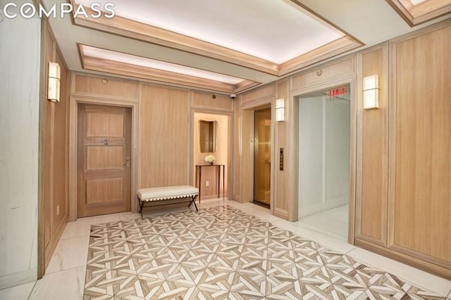 hallway featuring light tile patterned floors and wood walls