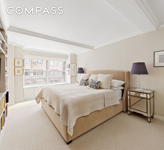 bedroom featuring baseboards, light carpet, and crown molding