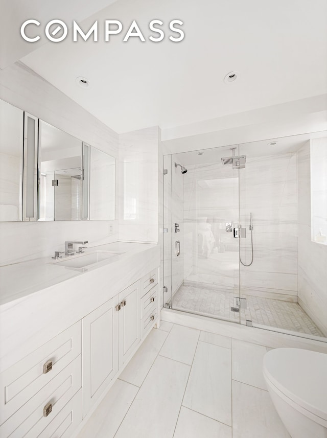 bathroom featuring a shower stall, vanity, and toilet