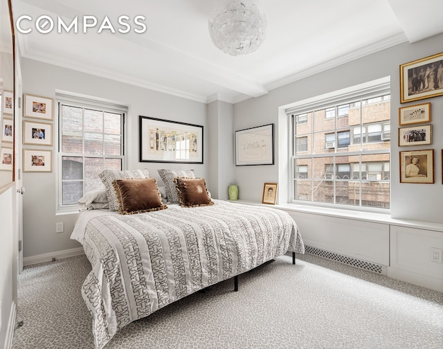 carpeted bedroom with crown molding, baseboards, and visible vents