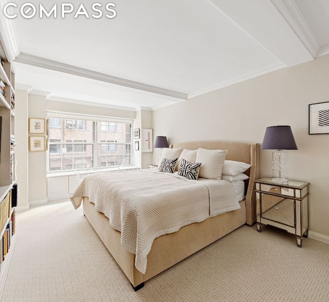 bedroom with beamed ceiling, ornamental molding, and carpet flooring