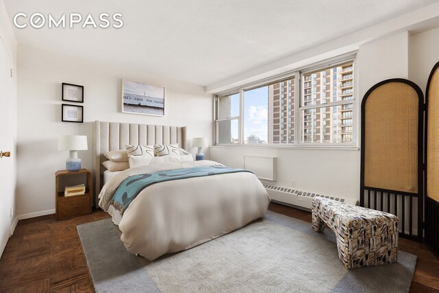 bedroom with baseboards and a baseboard heating unit