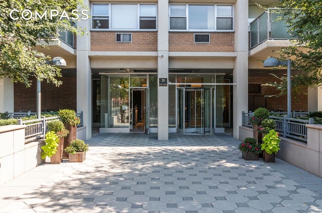 entrance to property featuring brick siding