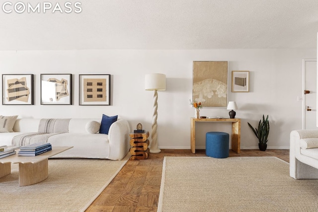 living room with parquet floors and a textured ceiling