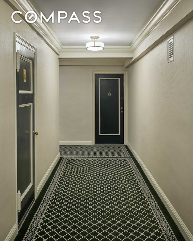 corridor featuring crown molding and baseboards