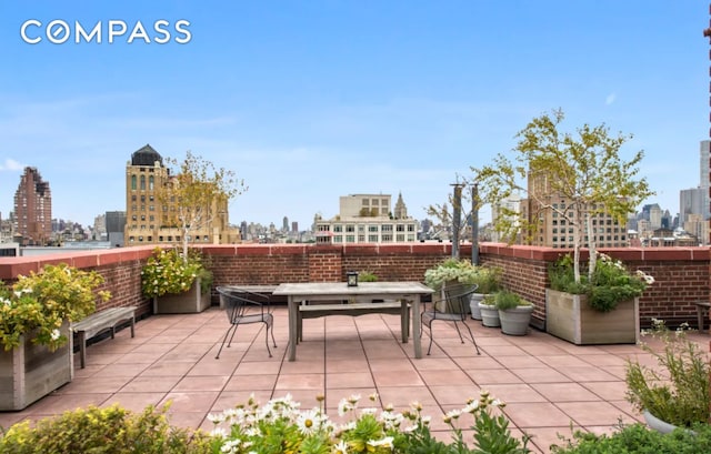 view of patio with a view of city and outdoor dining area