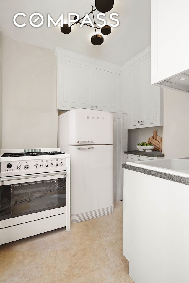 kitchen with white cabinets and white appliances