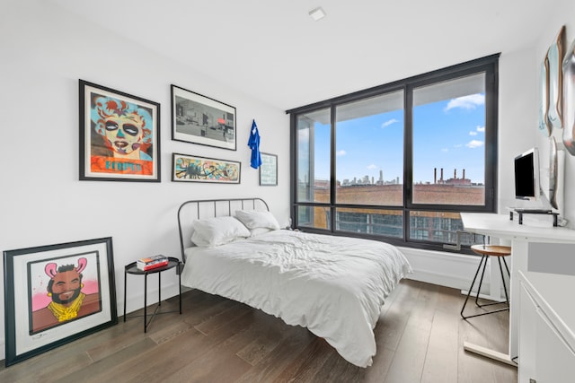 bedroom with dark wood-type flooring