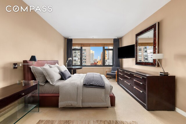 bedroom featuring light colored carpet