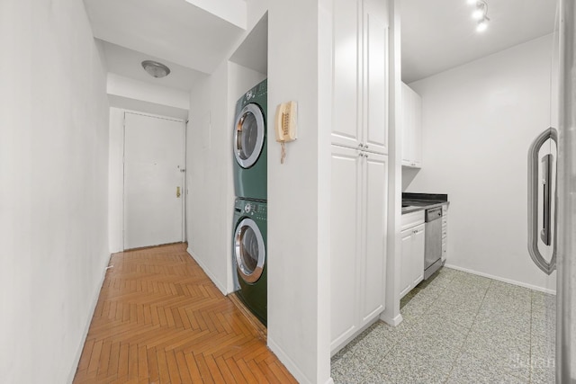 laundry area featuring light parquet floors and stacked washing maching and dryer