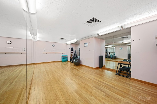 exercise area with hardwood / wood-style flooring