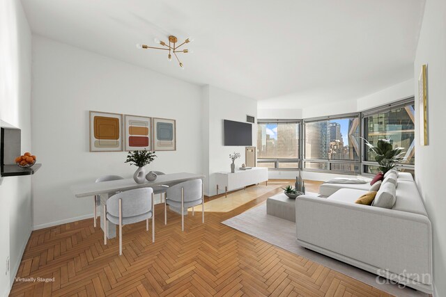 unfurnished living room with parquet flooring and a chandelier