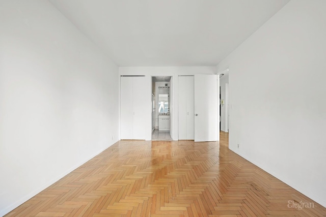 unfurnished bedroom featuring light parquet floors