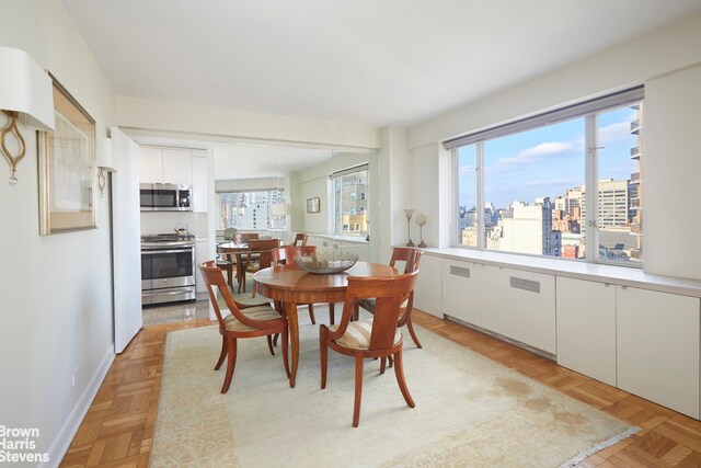 dining space with light parquet floors