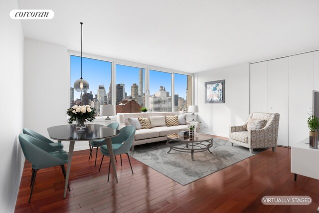 living room featuring hardwood / wood-style flooring and a wall of windows