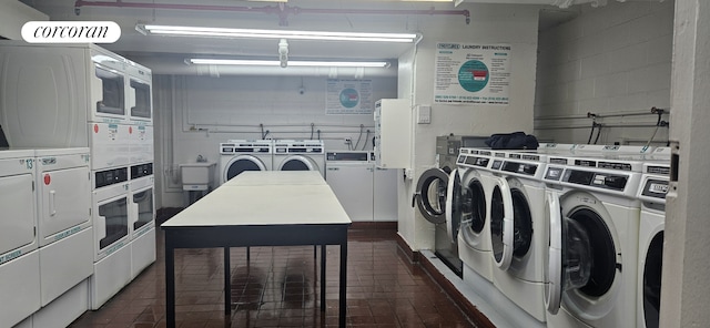 laundry room with stacked washer and dryer and washing machine and dryer