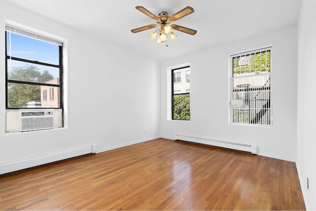 unfurnished room with a baseboard radiator, cooling unit, ceiling fan, and light wood-type flooring