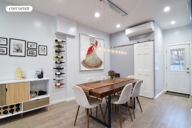 dining room featuring a wall mounted air conditioner, visible vents, light wood-style flooring, and recessed lighting