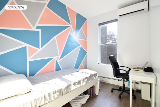 bedroom with a wall mounted air conditioner and wood finished floors