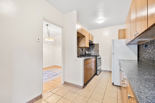 kitchen with stainless steel gas stove, sink, tasteful backsplash, and light tile patterned flooring