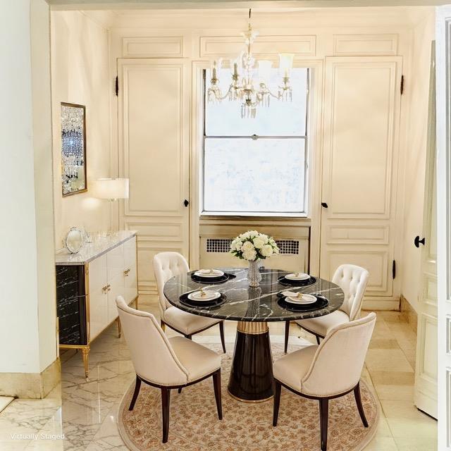 dining room with radiator and a notable chandelier