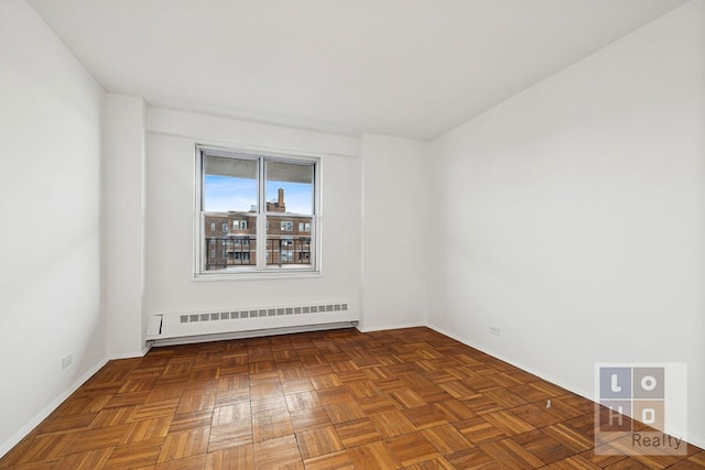 577 Grand St Unit F1904, New York City, NY 10002 - spare room featuring baseboard heating, baseboards, and radiator heating unit