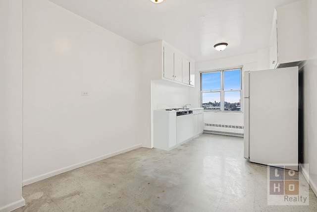 interior space featuring white cabinetry, a baseboard radiator, and white fridge