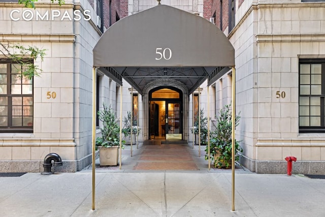 property entrance with a carport