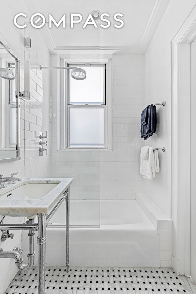 full bath featuring tile patterned flooring, shower / tub combination, and a sink
