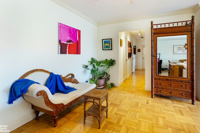 sitting room featuring baseboards and crown molding