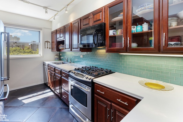 kitchen featuring a sink, light countertops, backsplash, and stainless steel appliances