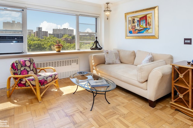 living room featuring a city view, radiator, and ornamental molding