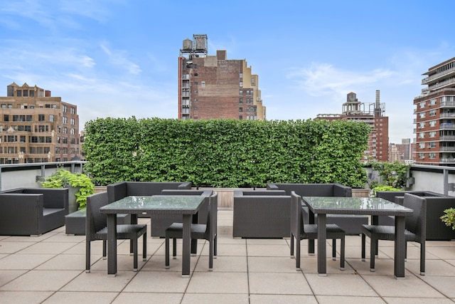 view of patio featuring a city view and outdoor dining space