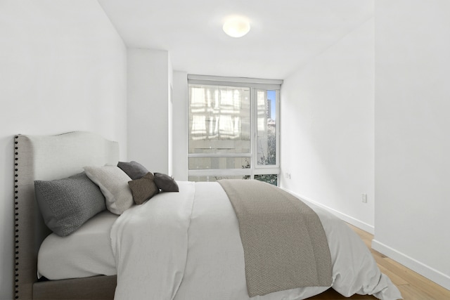 bedroom with baseboards and light wood-style floors