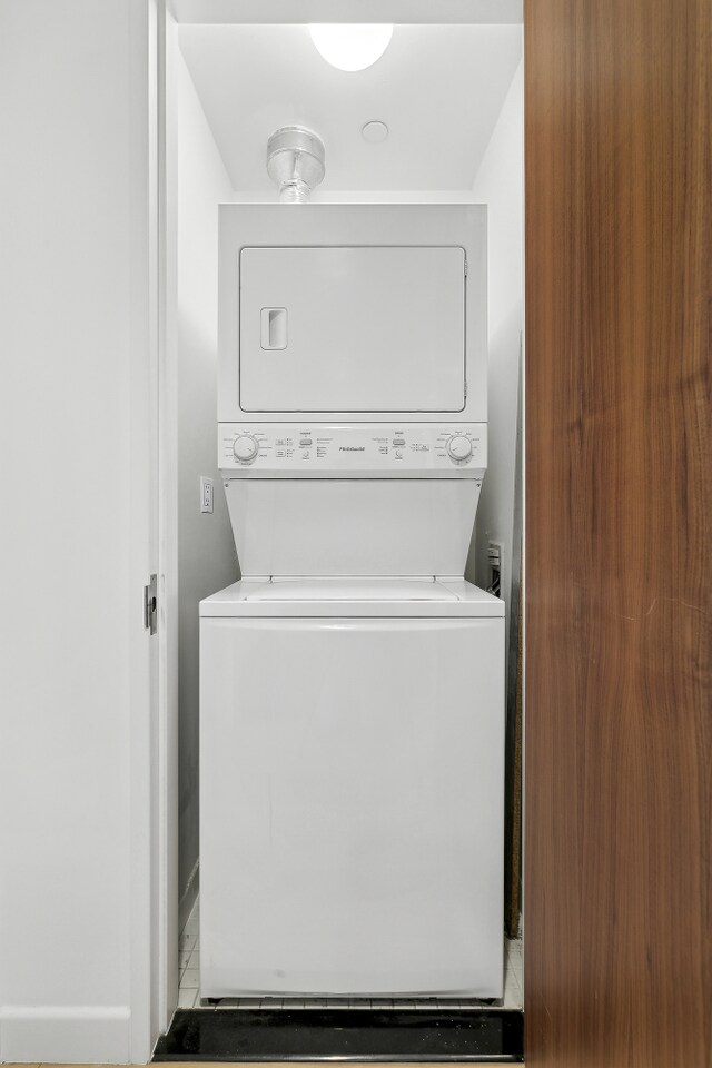 clothes washing area featuring laundry area and stacked washer / dryer