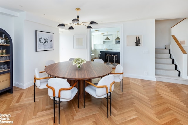 dining space with light parquet flooring