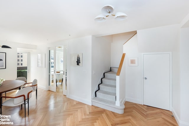 entrance foyer with baseboards and stairs