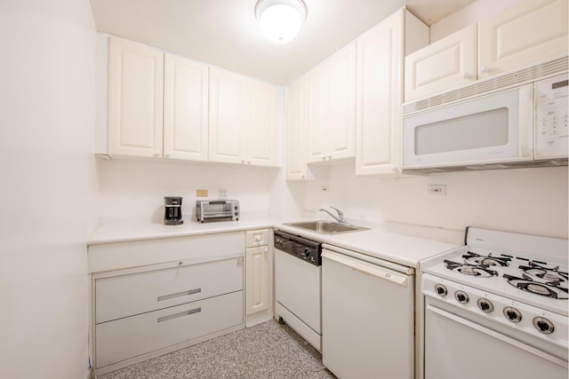 kitchen featuring light countertops, white cabinetry, a sink, and white appliances