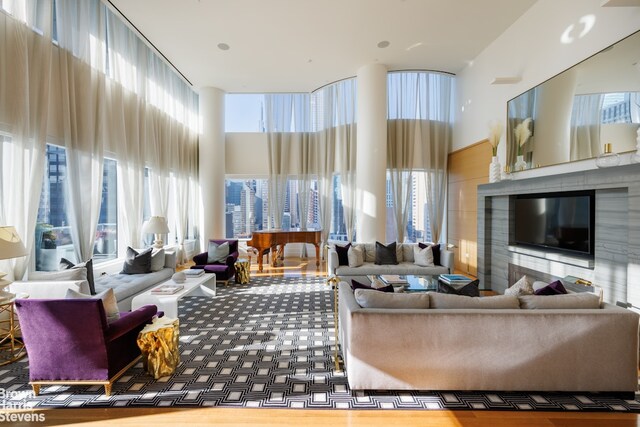 living room featuring an inviting chandelier, a wealth of natural light, and ornamental molding