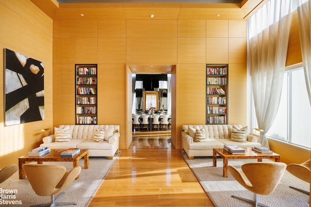 living room with built in features, a healthy amount of sunlight, and a high ceiling