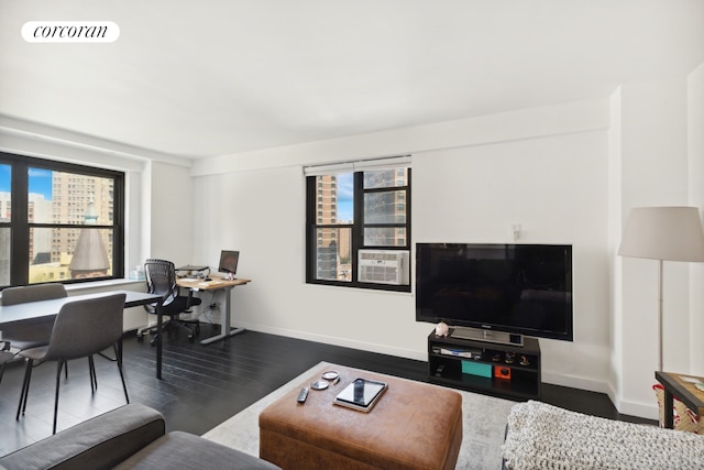 living room featuring a wealth of natural light, visible vents, baseboards, and dark wood-style floors