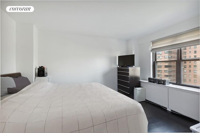 bedroom with visible vents and dark wood-style floors