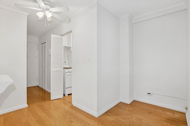 interior space with crown molding, ceiling fan, and light hardwood / wood-style floors