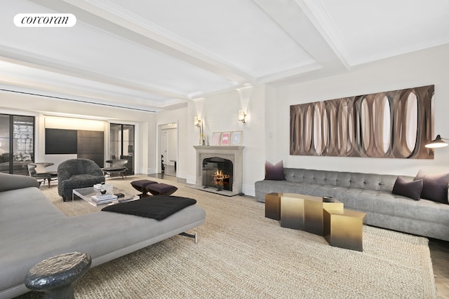 living room with ornamental molding and beam ceiling