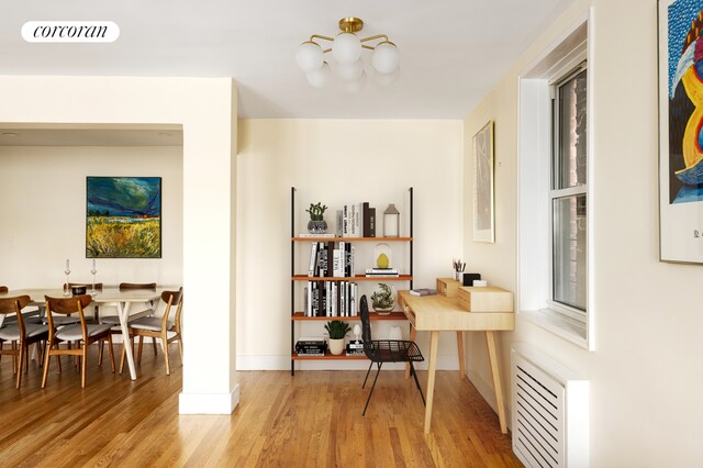 office with wood finished floors, a chandelier, and baseboards