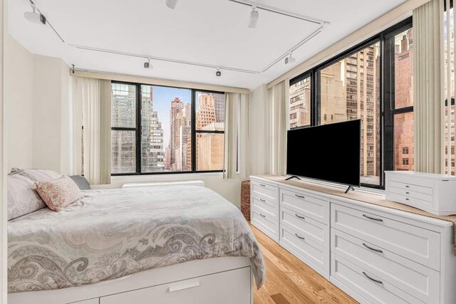 301 E 45th St Unit 10E, New York City, NY 10017 - bedroom featuring ceiling fan and light hardwood / wood-style floors