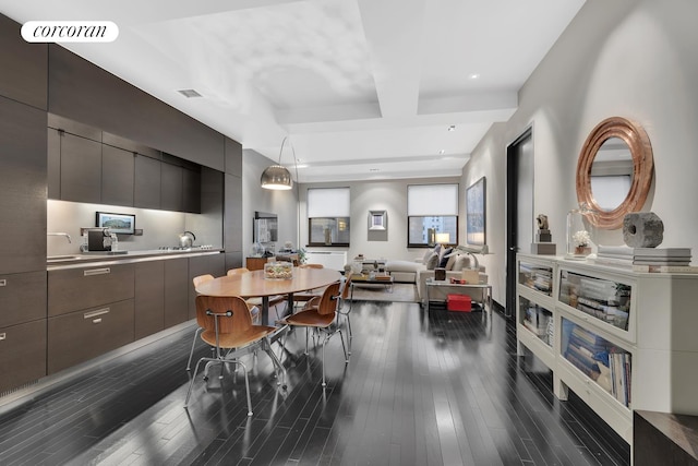 dining area featuring beam ceiling, visible vents, and dark wood finished floors