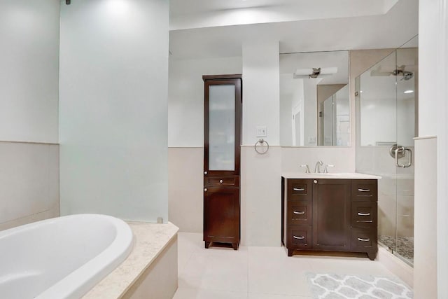 bathroom featuring vanity, tile patterned floors, and plus walk in shower