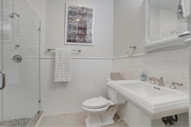 bathroom with sink, tile walls, tile patterned flooring, walk in shower, and toilet