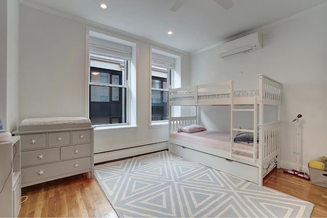 bedroom with ornamental molding, ceiling fan, baseboard heating, a wall unit AC, and light hardwood / wood-style flooring